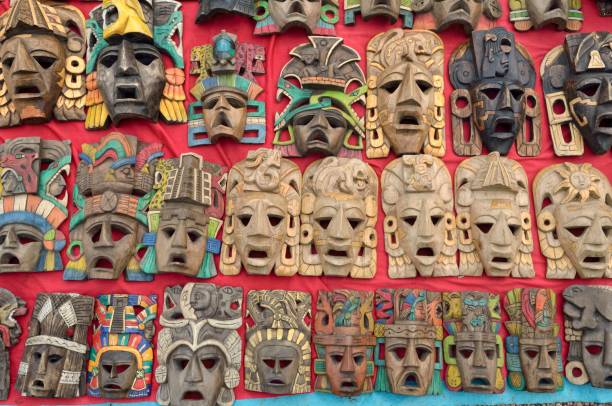 wooden masks at a souvenir stand, mayan ruins of palenque, chiapas, mexico - palenque photos et images de collection