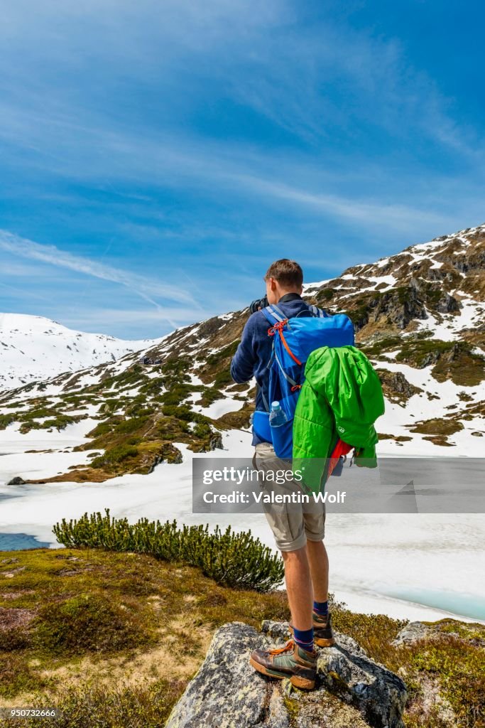Young man, hiker photographing, Rohrmoos-Untertal, Schladming Tauern, Schladming, Styria, Austria