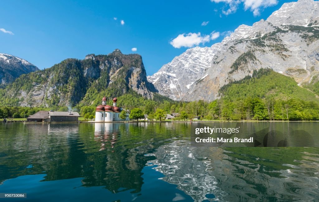 Reflection in the water, Koenigssee lake with Watzmann Massif and pilgrimage church of St. Bartholomew, National Park Berchtesgaden, Berchtesgadener, Upper Bavaria, Bavaria, Germany
