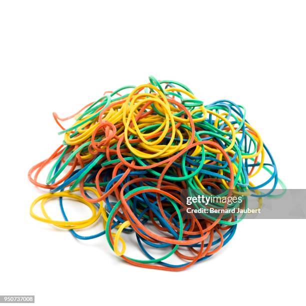 multicolored elastics on pile on white background, cutout - bernard jaubert stock pictures, royalty-free photos & images