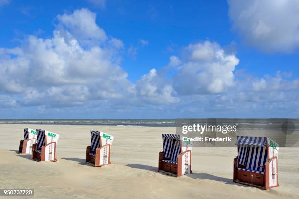 blue-white beach chairs on the east beach white dune with blue clouds, norderney, east frisian islands, north sea, lower saxony, germany - norderney stock pictures, royalty-free photos & images