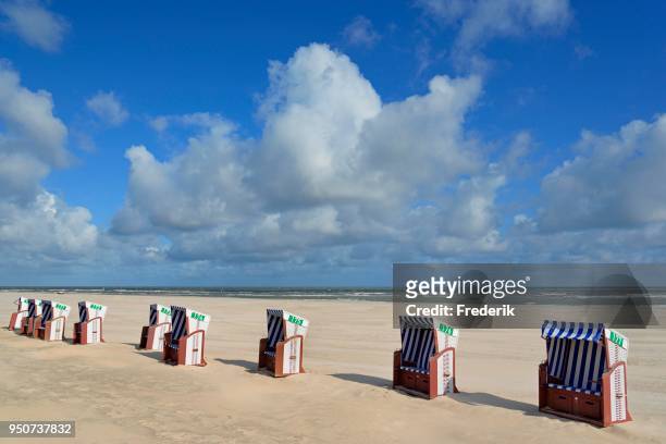 blue-white beach chairs on the east beach white dune with blue clouds, norderney, east frisian islands, north sea, lower saxony, germany - norderney stock pictures, royalty-free photos & images