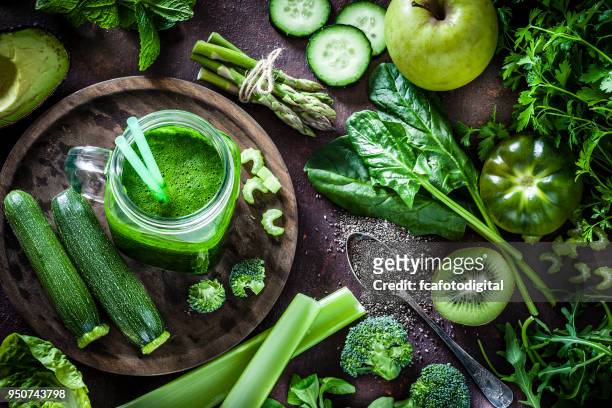 detox diet concept: green vegetables on rustic table - leaf vegetable stock pictures, royalty-free photos & images