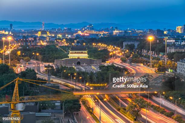 night view of illuminated road and qianmen gate, beijing, china - qianmen stock pictures, royalty-free photos & images