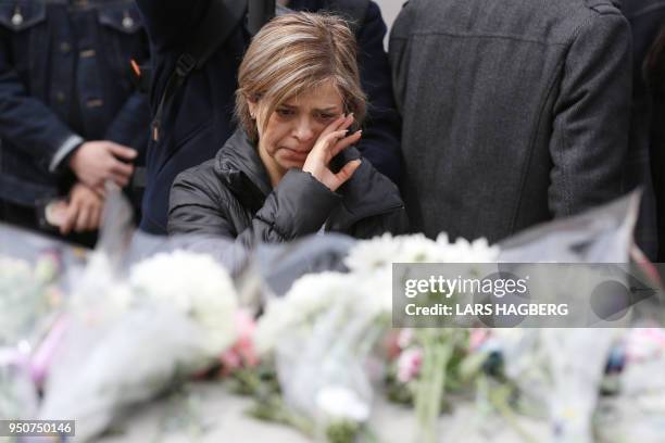 Woman grieves by a makeshift memorial for victims of the van attack, in Toronto, Ontario, on April 24, 2018. - A van driver who ran over 10 people...