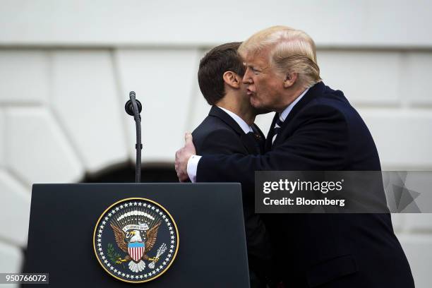 President Donald Trump greets Emmanuel Macron, France's president, left, at an arrival ceremony during a state visit in Washington, D.C., U.S., on...