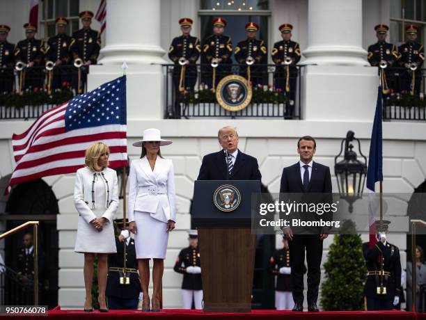 President Donald Trump, center, speaks while Emmanuel Macron, France's president, from right, U.S. First Lady Melania Trump, and Brigitte Macron,...