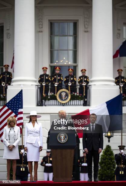 President Donald Trump, center, speaks while Emmanuel Macron, France's president, from right, U.S. First Lady Melania Trump, and Brigitte Macron,...