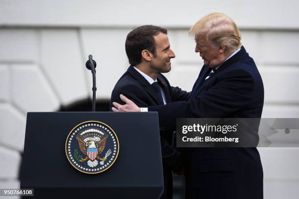 Emmanuel Macron, France's president, greets U.S. President Donald Trump, right, at an arrival ceremony during a state visit in Washington, D.C.,...