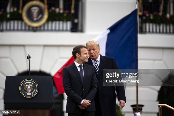 President Donald Trump, center, speaks with Emmanuel Macron, France's president, left, at an arrival ceremony during a state visit in Washington,...