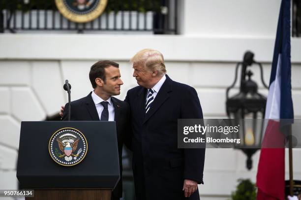 Emmanuel Macron, France's president, left, greets U.S. President Donald Trump, at an arrival ceremony during a state visit in Washington, D.C., U.S.,...