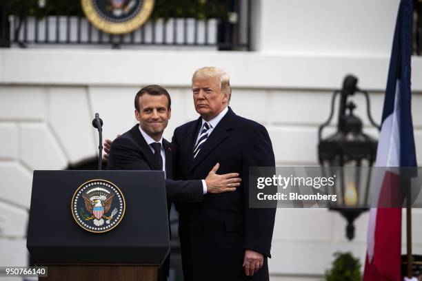 Emmanuel Macron, France's president, left, greets U.S. President Donald Trump, at an arrival ceremony during a state visit in Washington, D.C., U.S.,...