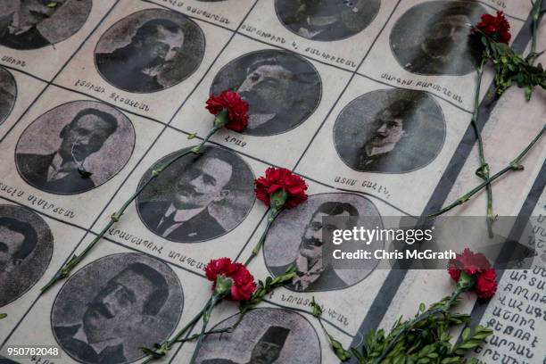 Roses are seen on the portraits of victims during a memorial to commemorate the 1915 Armenian mass killings on April 24, 2018 in Istanbul, Turkey....