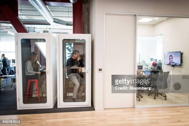 Employees of work in cubicles modeled after phone booths at the Mapbox Inc. Headquarters in San Francisco, California, U.S., on Monday, March 5,...