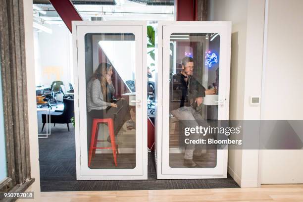 Employees of work in cubicles modeled after phone booths at the Mapbox Inc. Headquarters in San Francisco, California, U.S., on Monday, March 5,...