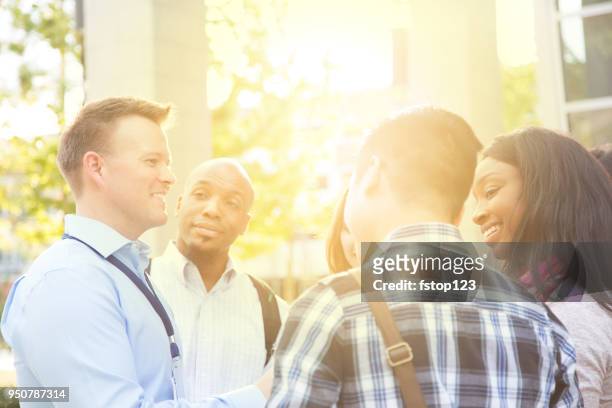 college recruiter gives campus tour to potential students. - college visit stock pictures, royalty-free photos & images