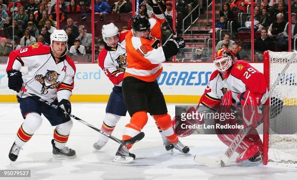 Mike Richards of the Philadelphia Flyers battles in the crease against Stephen Weiss, Jordan Leopold and Thomas Vokoun of the Florida Panthers on...