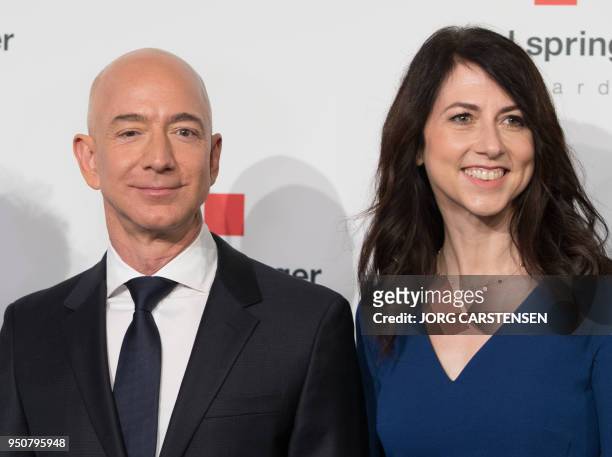 Amazon CEO Jeff Bezos and his wife MacKenzie Bezos poses as they arrive at the headquarters of publisher Axel-Springer where he will receive the Axel...