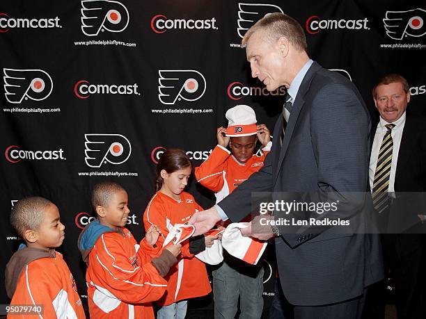 Comcast-Spectacor President Peter Luukko and Philadelphia Flyers General Manager Paul Holmgren present limited-edition Winter Classic hats and Flyers...