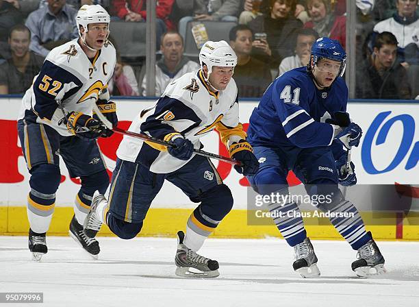 Tim Connolly of the Buffalo Sabres chases after a loose puck with Nikolai Kulemin of the Toronto Maple Leafs in pursuit in a game on December 21,...