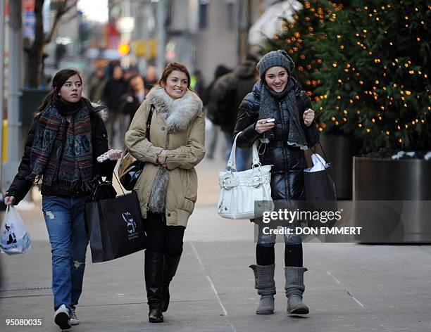 Christmas shoppers walk along 57th Street in Manhattan December 23, 2009 in New York. With just two days left to shop before Christmas some...