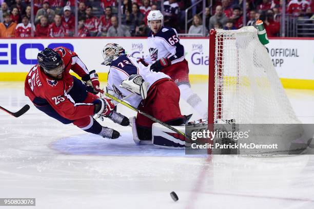 Devante Smith-Pelly of the Washington Capitals and Sergei Bobrovsky of the Columbus Blue Jackets collide in the third period in Game Five of the...