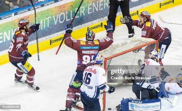 Nick Petersen of Eisbaeren Berlin celebrates with team mates after scoring his team's second goal against goalkeeper Danny aus den Birken of Red Bull...