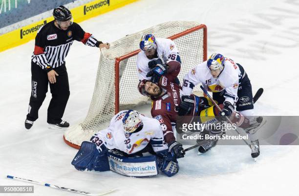James Sheppard of Eisbaeren Berlin is tackled by players of Red Bull Muenchen during the DEL Playoff final match 6 between Eisbaeren Berlin and EHC...