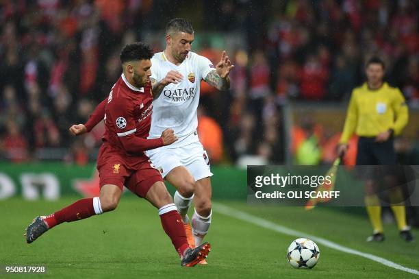 Liverpool's English midfielder Alex Oxlade-Chamberlain vies with Roma's Croatian defender Aleksandar Kolarov during the UEFA Champions League first...