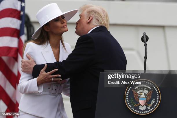 President Donald Trump kisses first lady Melania Trump during a state arrival ceremony at the South Lawn of the White House April 24, 2018 in...