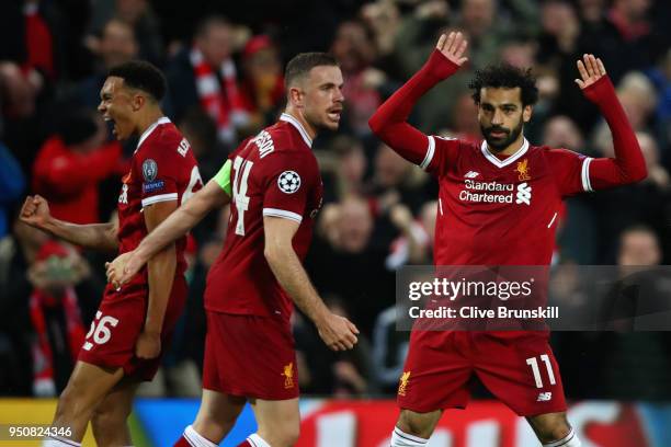 Mohamed Salah of Liverpool celebrates after scoring his sides first goal with team mates Jordan Henderson and Trent Alex Arnold of Liverpool during...