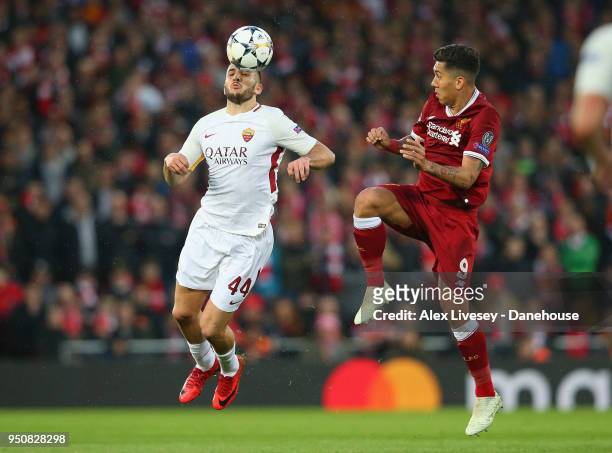 Kostas Manolas of A.S. Roma challenges Roberto Firmino of Liverpool during the UEFA Champions League Semi Final First Leg match between Liverpool and...