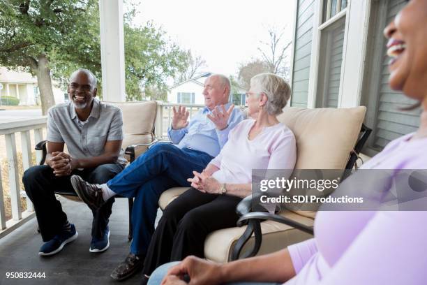 group of neighbors enjoy one another's company - neighbour stock pictures, royalty-free photos & images