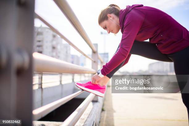 female athlete - untied shoelace stock pictures, royalty-free photos & images