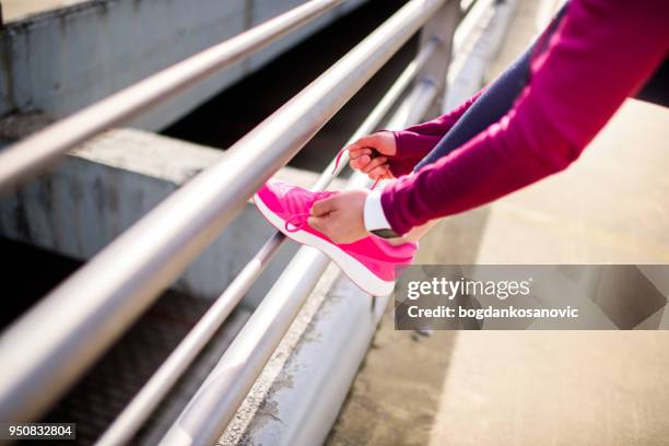 female athlete - untied shoelace stock pictures, royalty-free photos & images