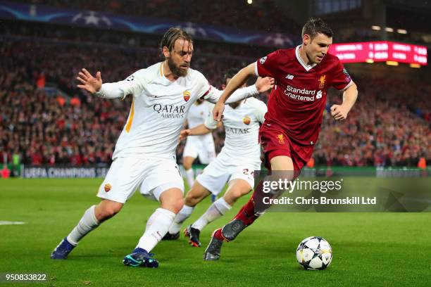 James Milner of Liverpool is challenged by Daniele De Rossi of AS Roma during the UEFA Champions League Semi Final First Leg match between Liverpool...