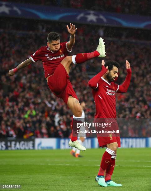 Mohamed Salah of Liverpool celebrates as he scores his sides second goal with Roberto Firmino during the UEFA Champions League Semi Final First Leg...