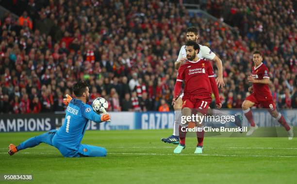 Mohamed Salah of Liverpool scores his sides second goal past Alisson Becker of AS Roma during the UEFA Champions League Semi Final First Leg match...