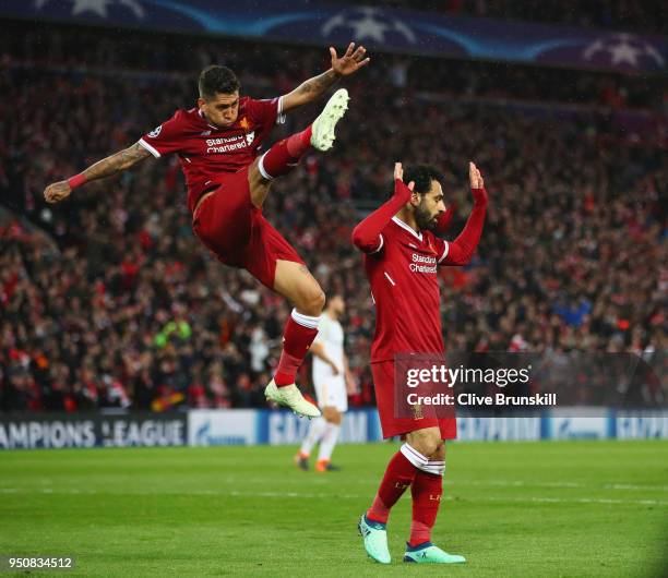 Mohamed Salah of Liverpool celebrates as he scores his sides second goal with Roberto Firmino during the UEFA Champions League Semi Final First Leg...