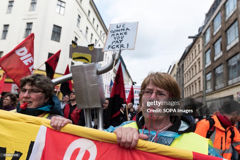 A protester blows a whistle during the demonstration against...