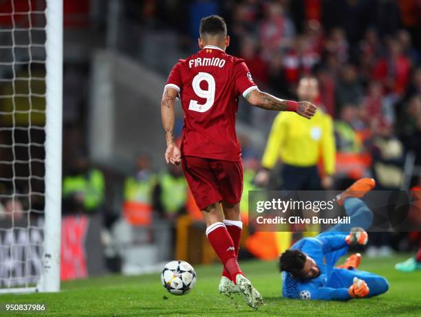 Roberto Firmino of Liverpool scores his sides fourth goal past Alisson Becker of AS Roma during the UEFA Champions League Semi Final First Leg match...