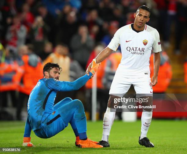 Juan Jesus of AS Roma assists team mates Alisson Becker of AS Roma during the UEFA Champions League Semi Final First Leg match between Liverpool and...