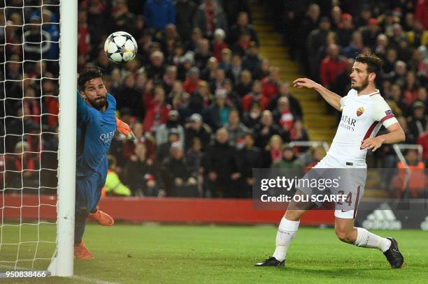 Roma's Brazilian goalkeeper Alisson fails to stop a goal by Liverpool's Brazilian midfielder Roberto Firmino during the UEFA Champions League first...