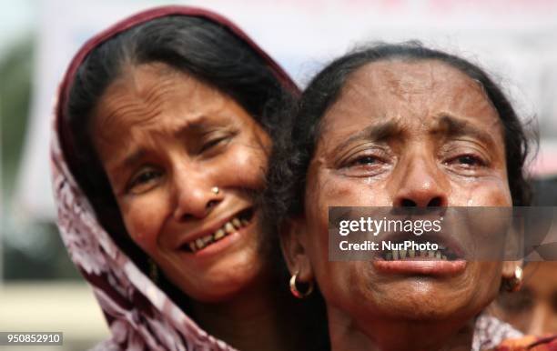 Relative of a victim killed in the Rana Plaza building collapse reacts as she and others mark the fifth anniversary of the disaster at the site where...