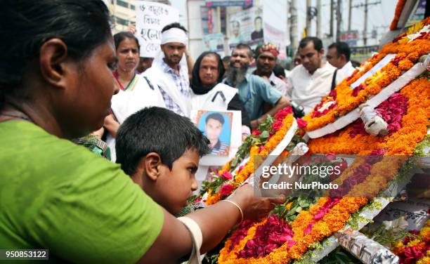 Floral wreath placed at the base of the hammer and scythe monument in Savar on the occasion of five years of Rana Plaza disaster in Dhaka, Bangladesh...