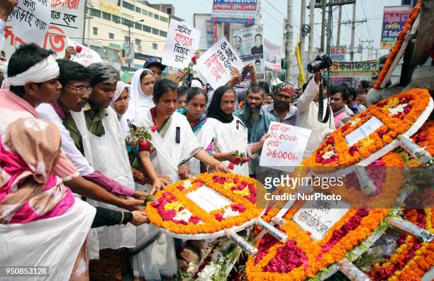 Floral wreath placed at the base of the hammer and scythe monument in Savar on the occasion of five years of Rana Plaza disaster in Dhaka, Bangladesh...