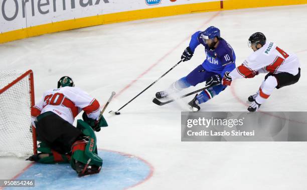 Adam Vay of Hungary watches Giulio Scandella of Italy and Tamas Pozsgai of Hungary behind during the 2018 IIHF Ice Hockey World Championship Division...