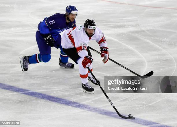 Tommaso Goi of Italy challenges Andrew Sarauer of Hungary during the 2018 IIHF Ice Hockey World Championship Division I Group A match between Italy...