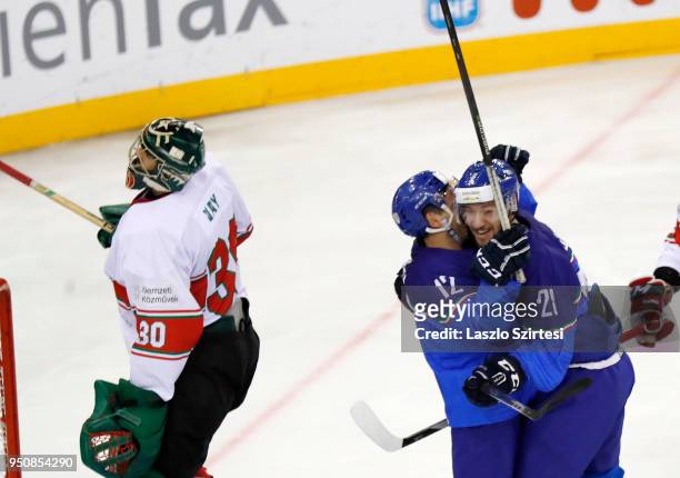 Tommaso Goi of Italy and Tommaso Traversa of Italy celebrate next to Adam Vay of Hungary during the 2018 IIHF Ice Hockey World Championship Division...