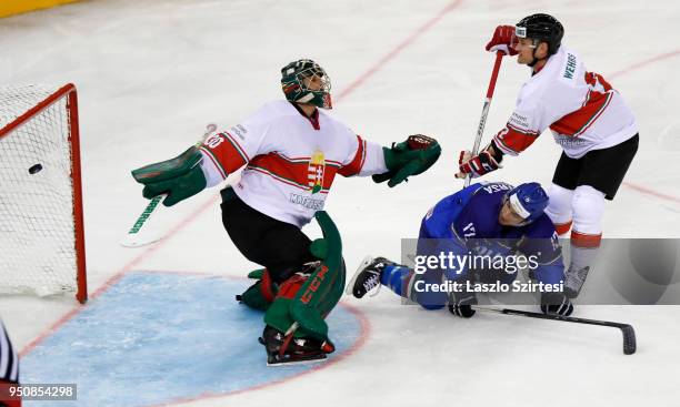 Adam Vay of Hungary cannot catch the puck next to Tommaso Traversa of Italy and Kevin Wehrs of Hungary during the 2018 IIHF Ice Hockey World...